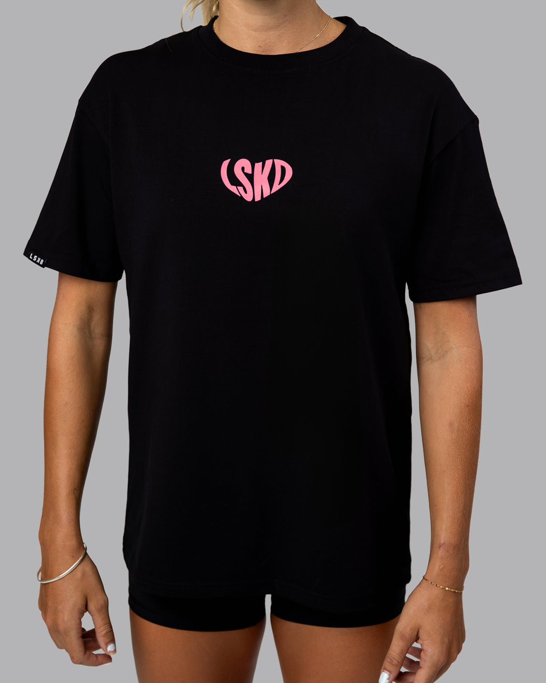 Woman wearing Unisex Love To Train FLXCotton Tee Oversize in Black-Pink Lemonade | Size:XS