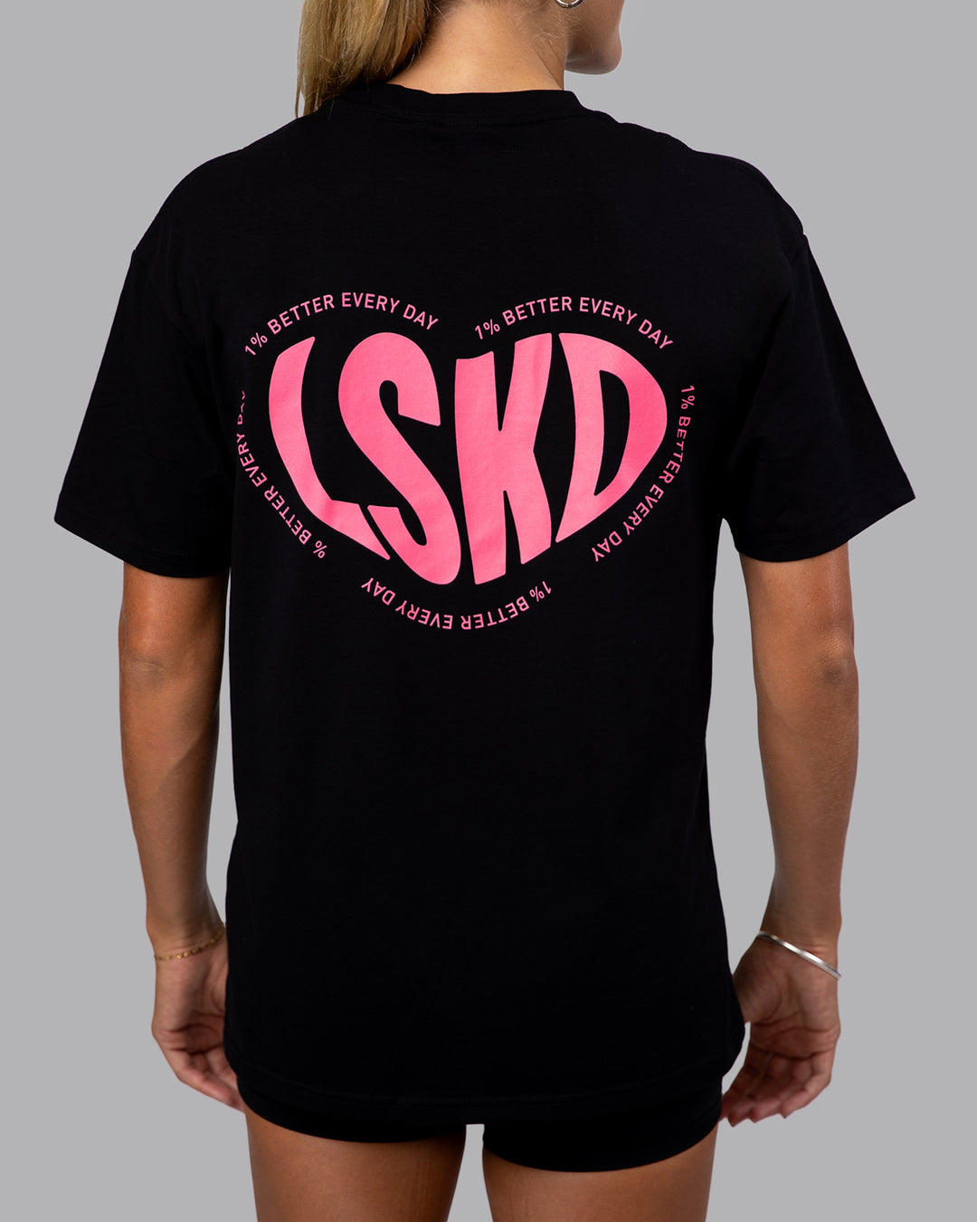 Woman wearing Unisex Love To Train FLXCotton Tee Oversize in Black-Pink Lemonade | Size:XS
