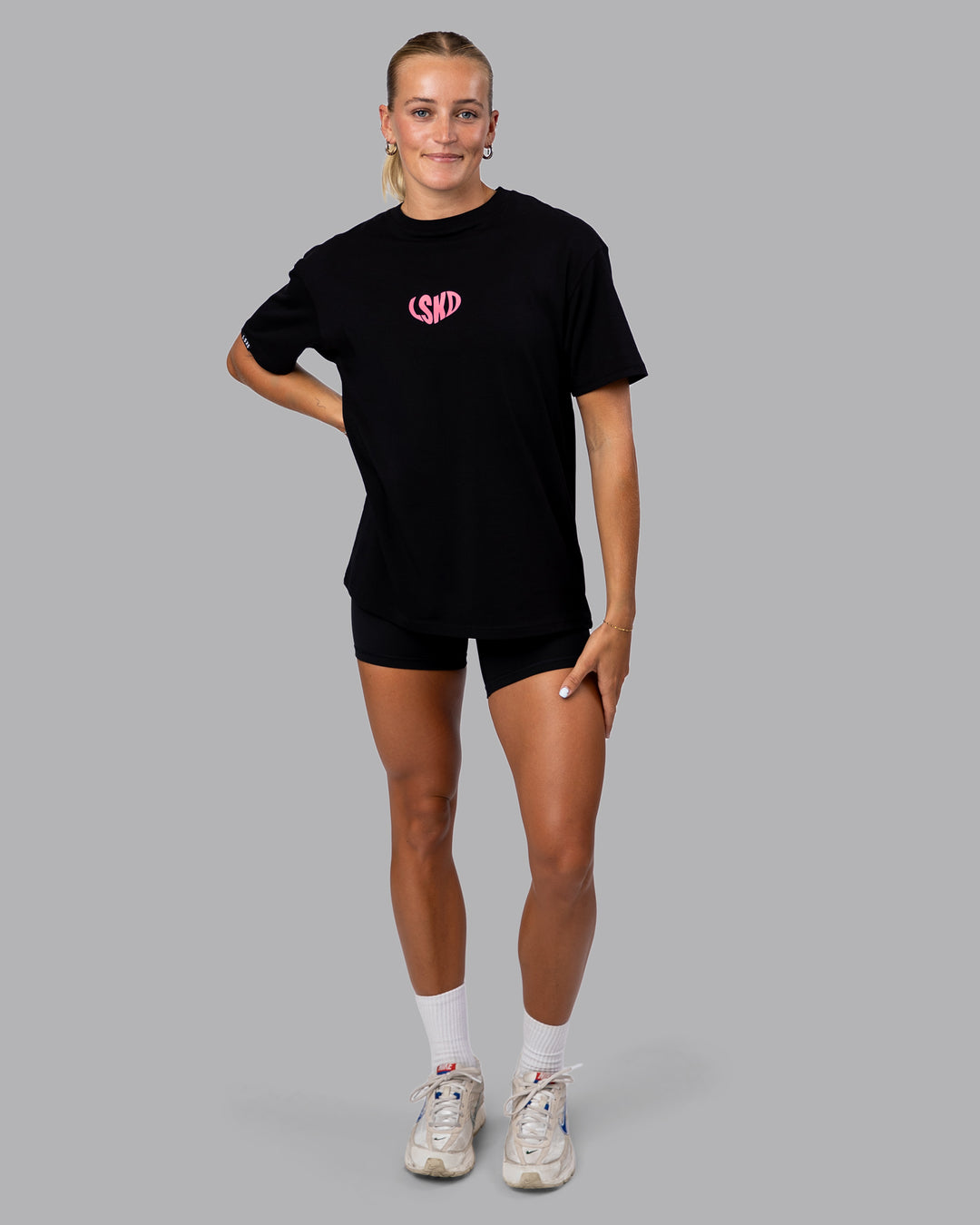 Woman wearing Unisex Love To Train FLXCotton Tee Oversize in Black-Pink Lemonade | Size:XS