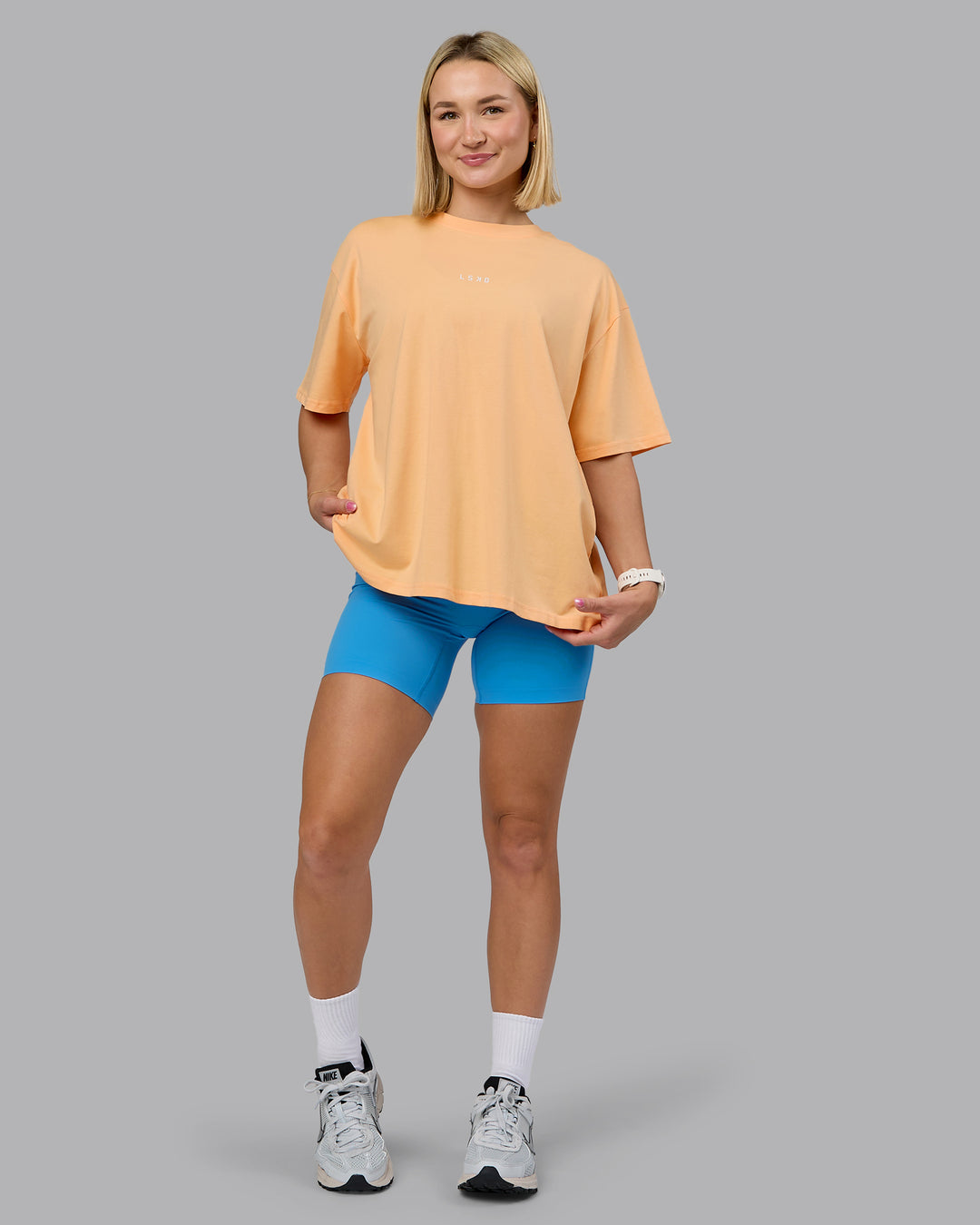 Woman wearing On Repeat FLXCotton Oversized Tee - Peach Fuzz-Light Cyan | Model:Halle | Size:S