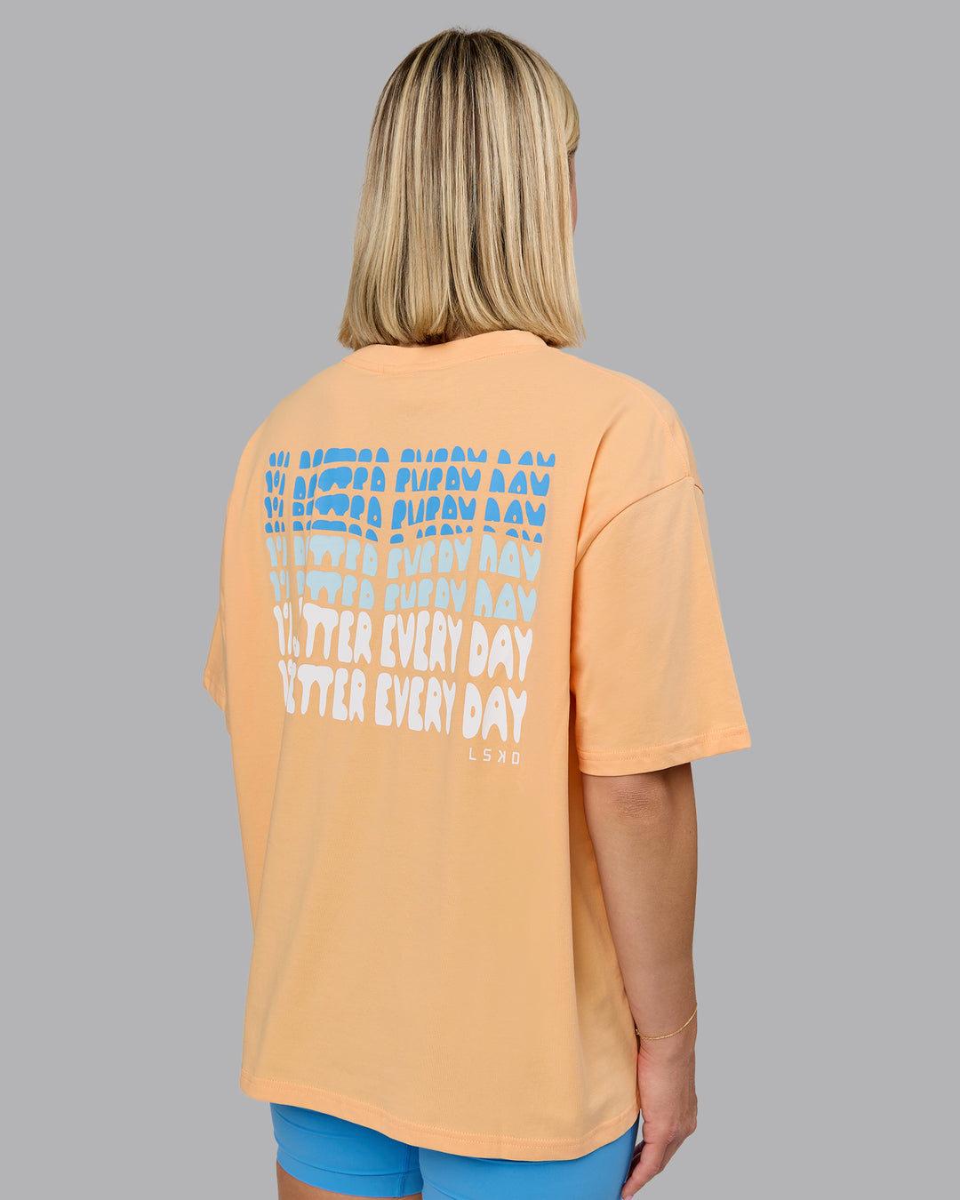 Woman wearing On Repeat FLXCotton Oversized Tee - Peach Fuzz-Light Cyan | Model:Halle | Size:S