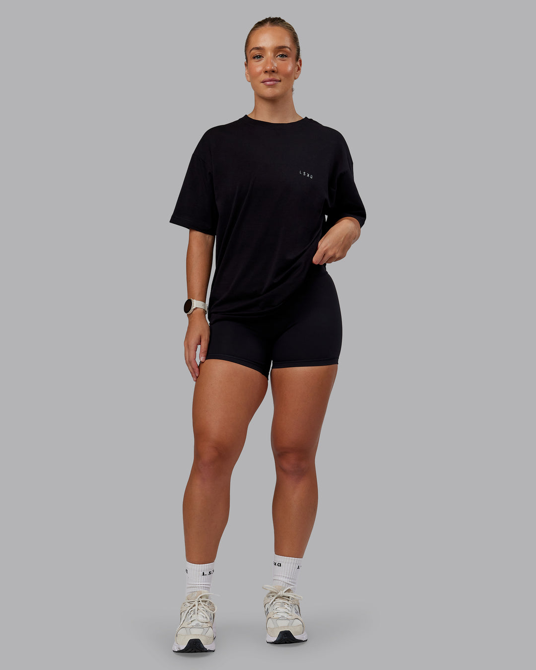 Woman wearing Unisex PimaFLX Tee Oversize - Black | Model:Lyss | Size:XS