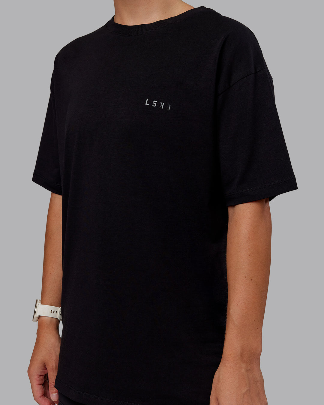 Woman wearing Unisex PimaFLX Tee Oversize - Black | Model:Lyss | Size:XS