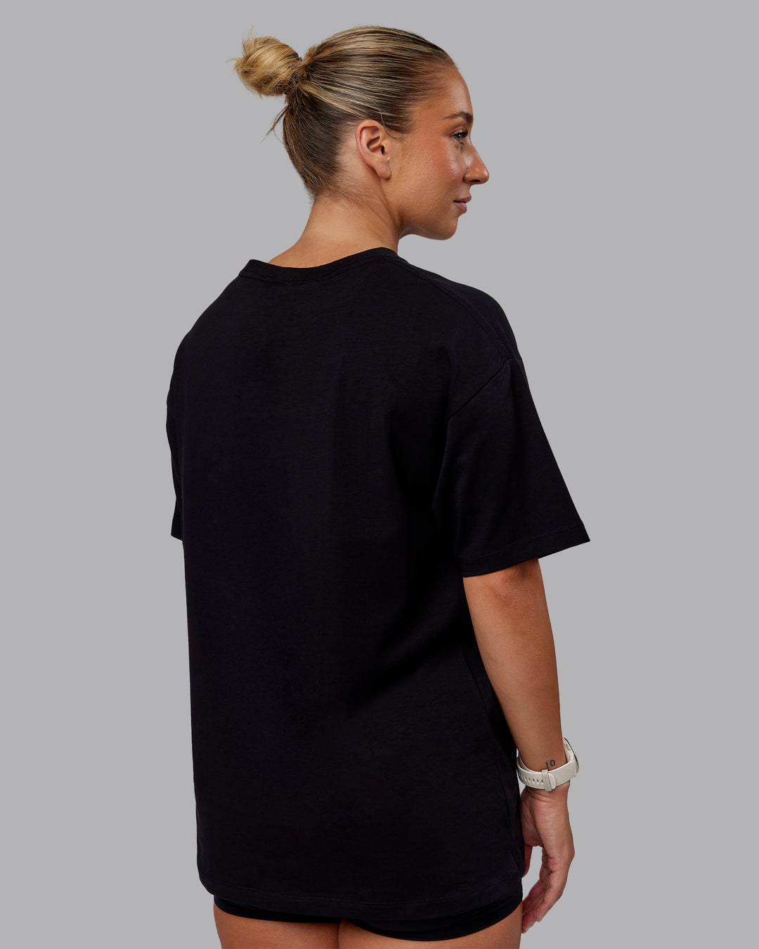 Woman wearing Unisex PimaFLX Tee Oversize - Black | Model:Lyss | Size:XS