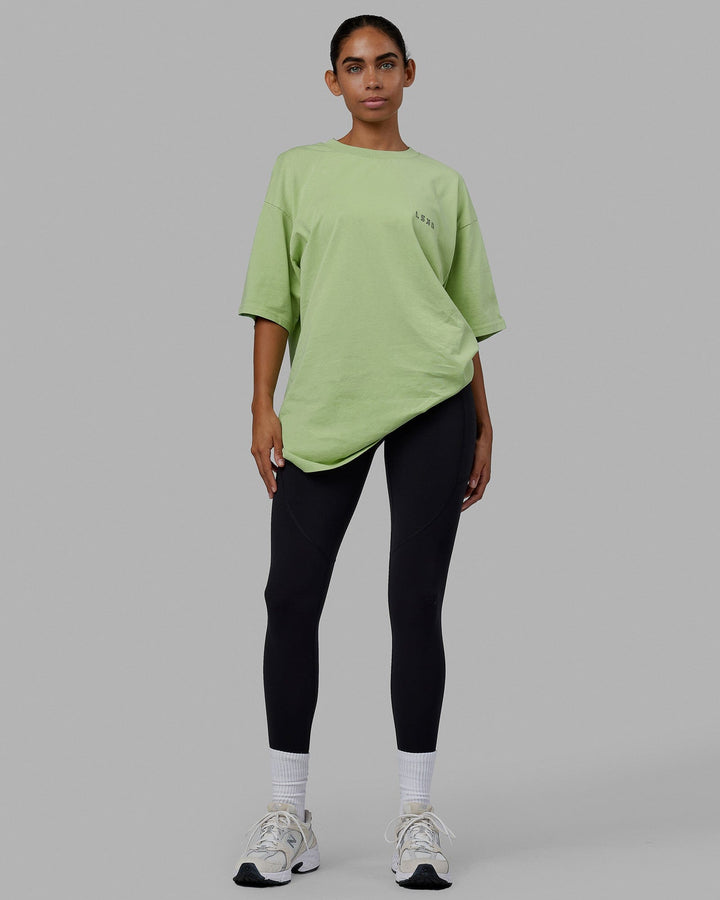 Woman wearing Unisex Rise & Lift Heavyweight Tee Oversize - Washed Green Fig