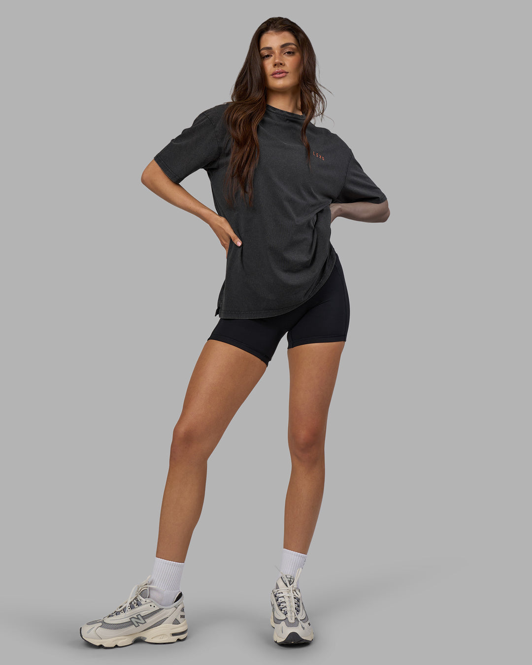 Woman wearing Unisex Strike Through FLXCotton Tee Oversize - Black Washed-Cantaloupe | Model:Phoebe | Size:XS