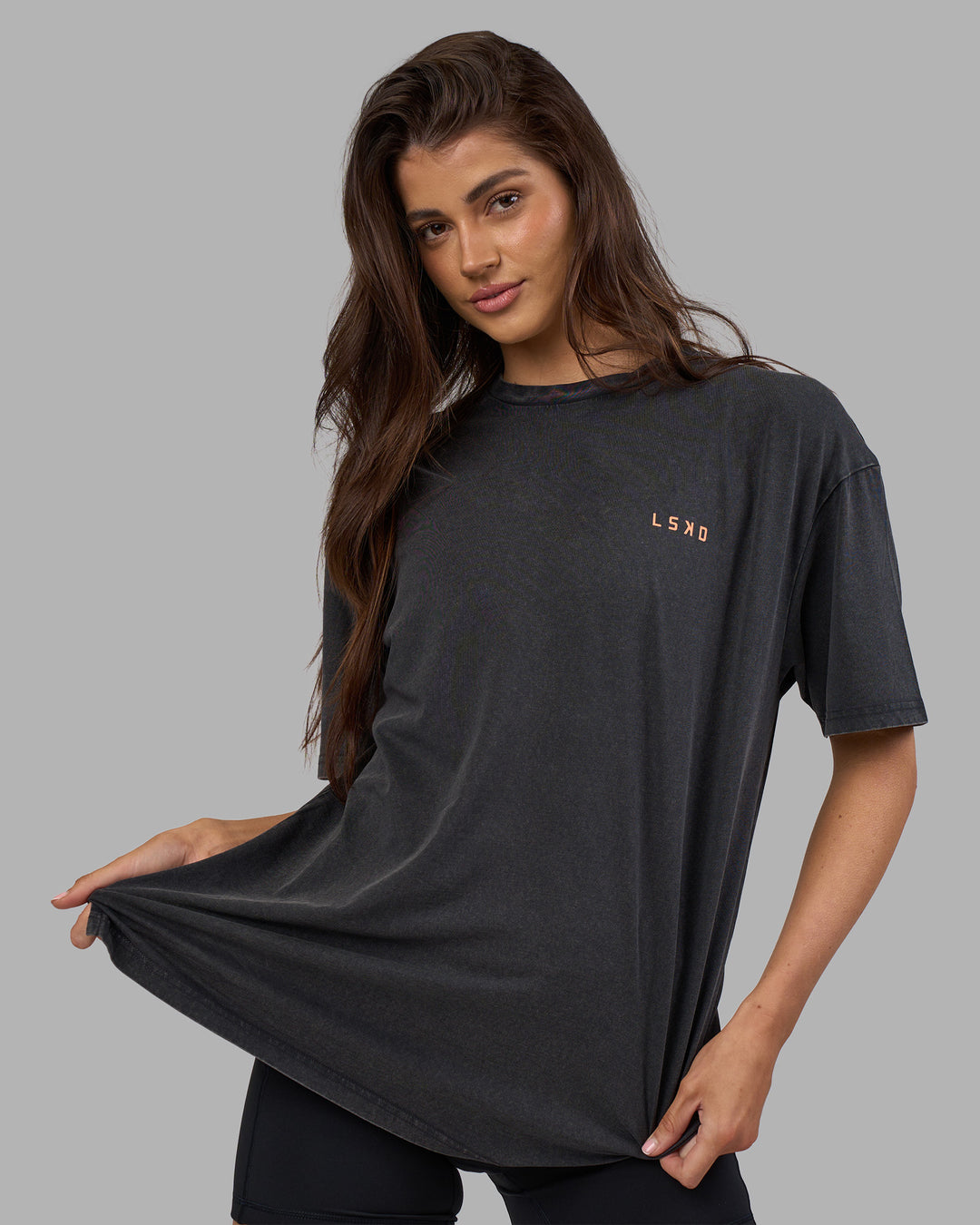 Woman wearing Unisex Strike Through FLXCotton Tee Oversize - Black Washed-Cantaloupe | Model:Phoebe | Size:XS