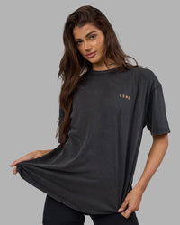 Woman wearing Unisex Strike Through FLXCotton Tee Oversize - Black Washed-Cantaloupe | Model:Phoebe | Size:XS
