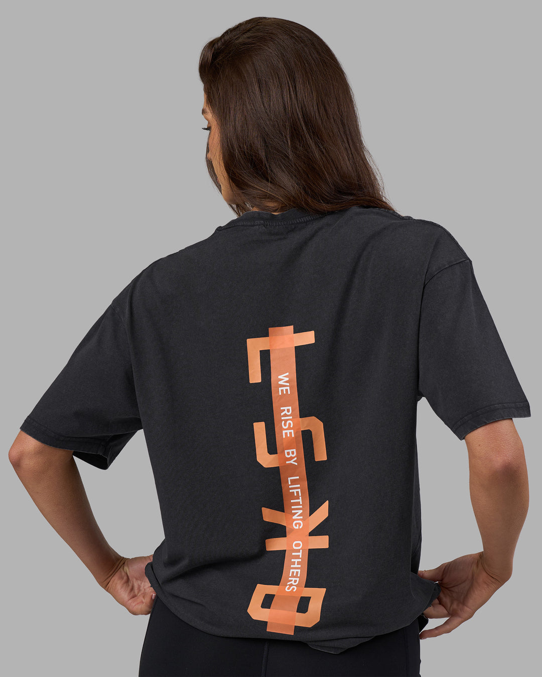 Woman wearing Unisex Strike Through FLXCotton Tee Oversize - Black Washed-Cantaloupe | Model:Phoebe | Size:XS