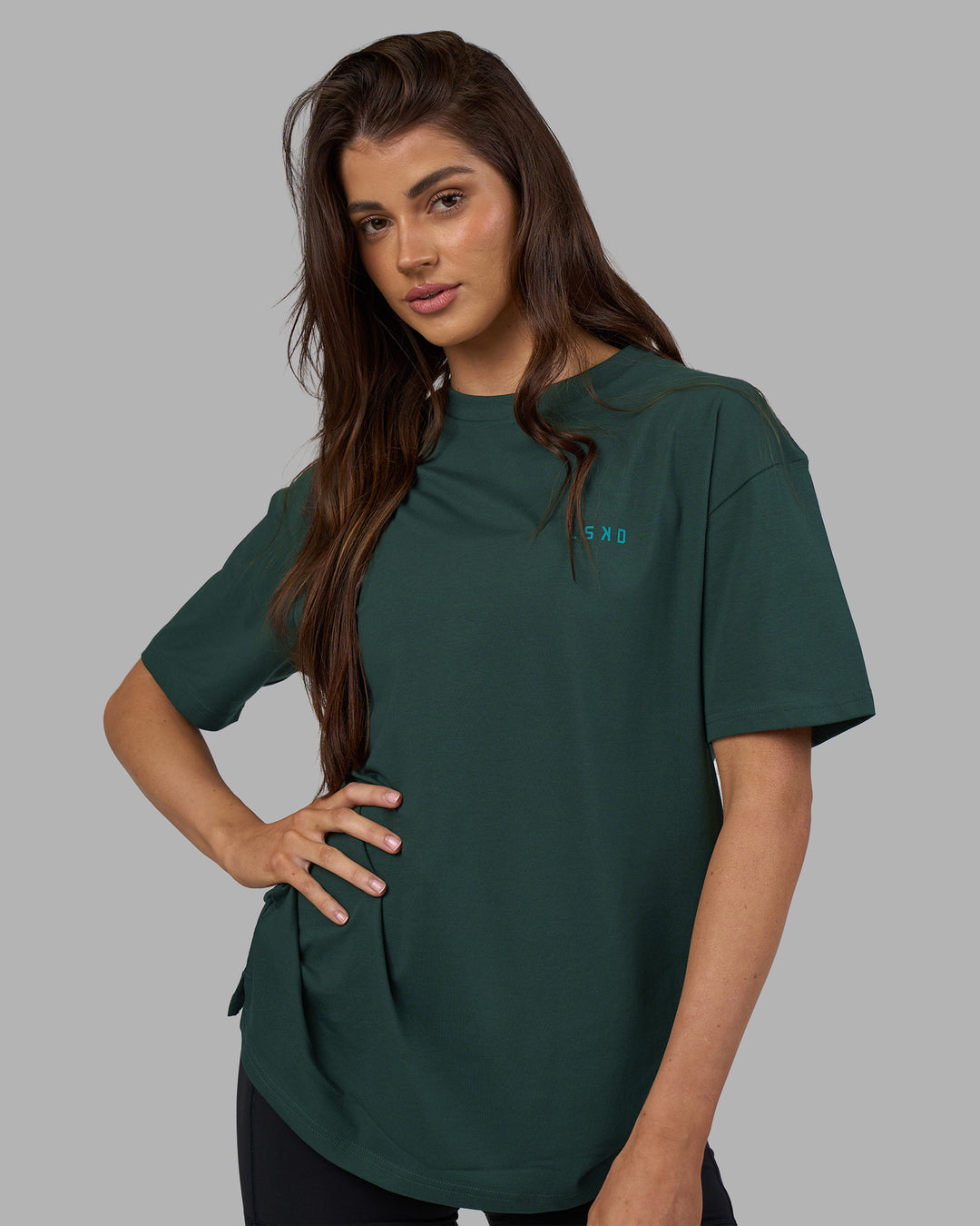 Woman wearing Unisex Strike Through FLXCotton Tee Oversize - Vital Green-Alexandrite | Model:Phoebe | Size:XS