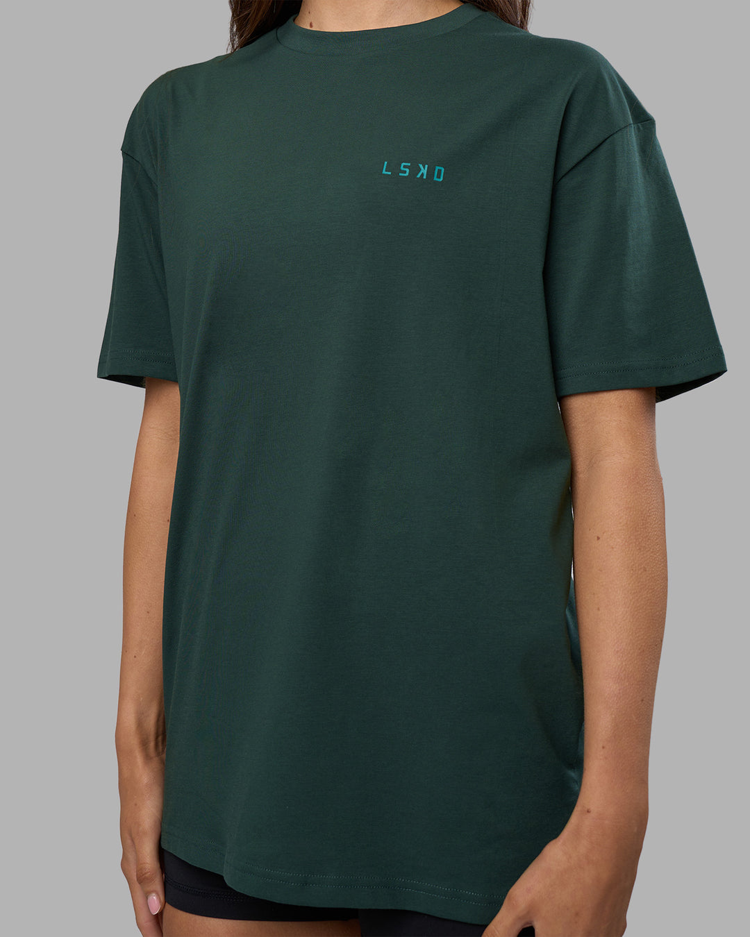 Woman wearing Unisex Strike Through FLXCotton Tee Oversize - Vital Green-Alexandrite | Model:Phoebe | Size:XS