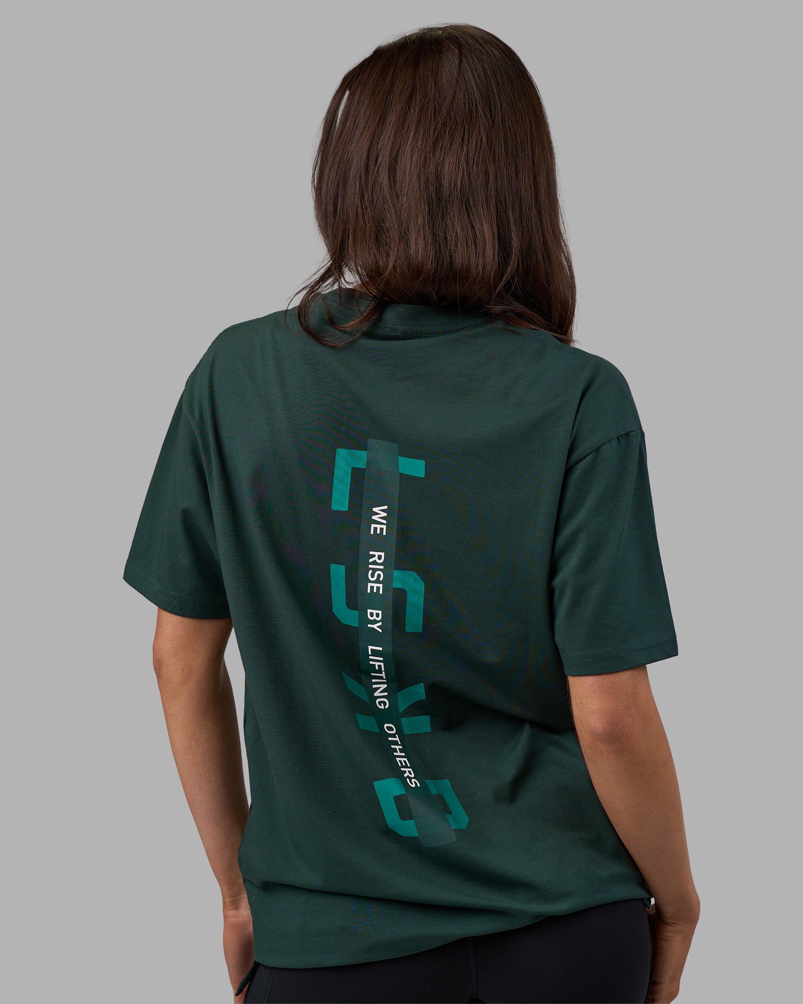Woman wearing Unisex Strike Through FLXCotton Tee Oversize - Vital Green-Alexandrite | Model:Phoebe | Size:XS