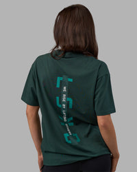 Woman wearing Unisex Strike Through FLXCotton Tee Oversize - Vital Green-Alexandrite | Model:Phoebe | Size:XS