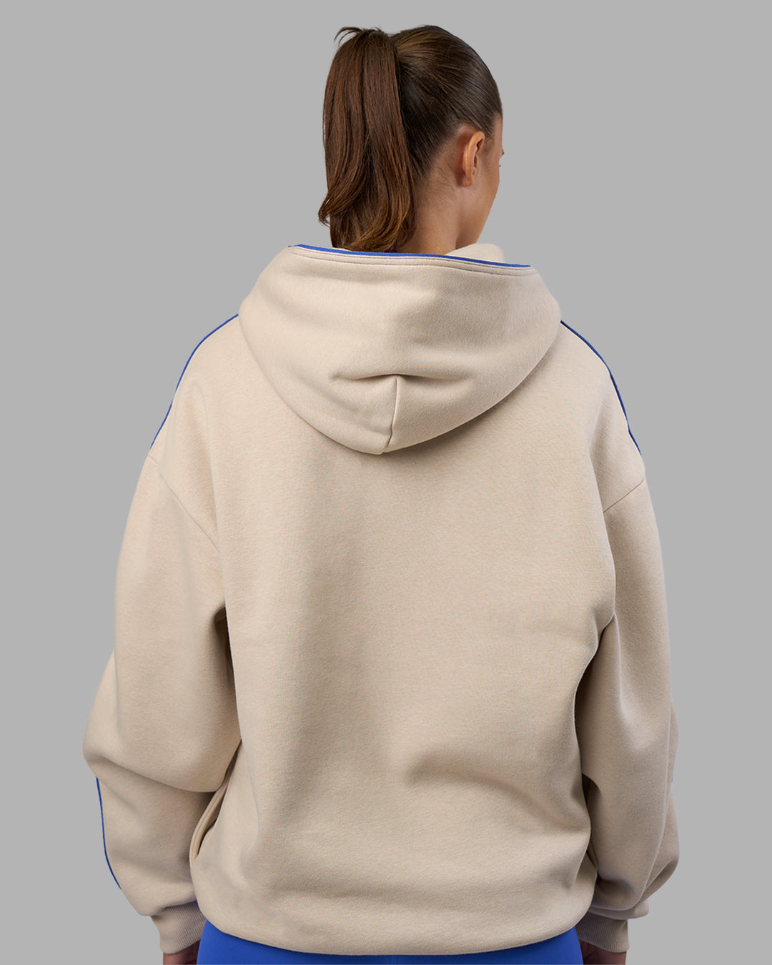 Woman wearing Unisex Oversized Piping Hoodie - Shale Beige-Power Cobalt | Model:Charlize | Size:XS
