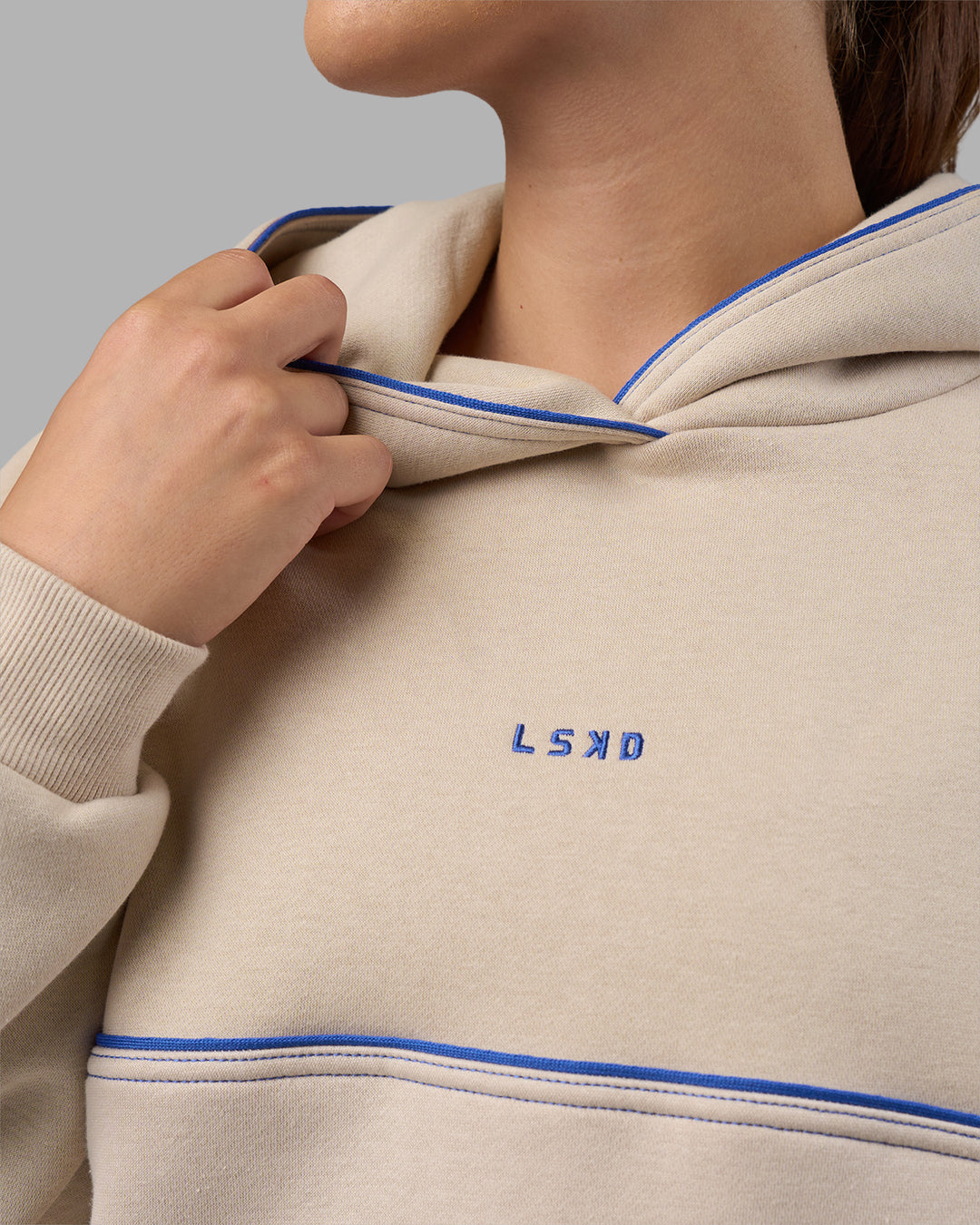 Woman wearing Unisex Oversized Piping Hoodie - Shale Beige-Power Cobalt | Model:Charlize | Size:XS