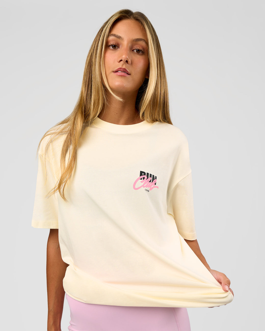 Woman wearing Values Run Club FLXCotton Tee - Off White-Candy Pink | Model:Georgia | Size:XS