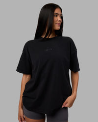 Woman wearing Variation Heavyweight FLXCotton Oversized Tee - Black-Black | Model:Rhiley | Size:XS