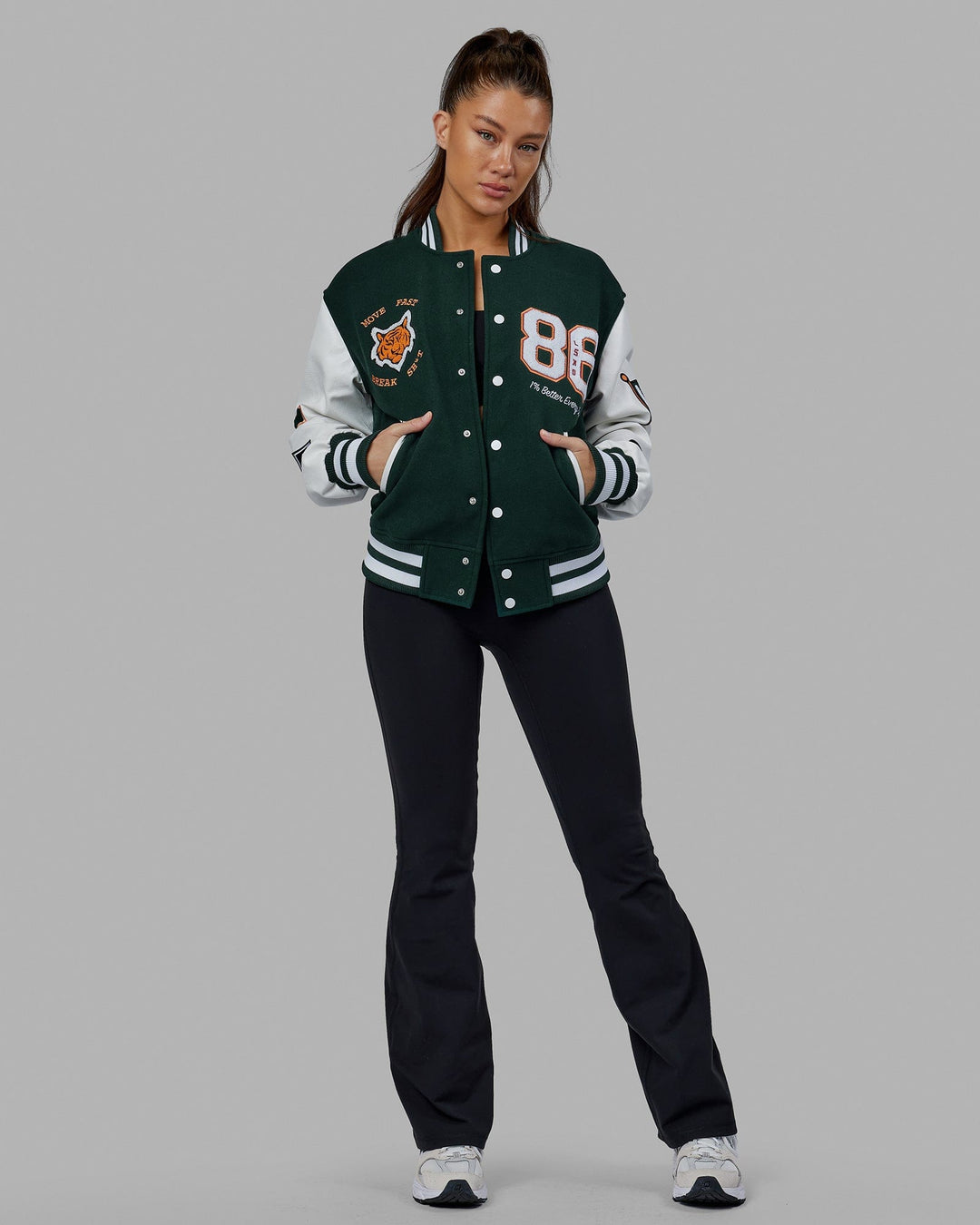 Woman wearing Unisex Varsity Bomber Jacket - Vital Green