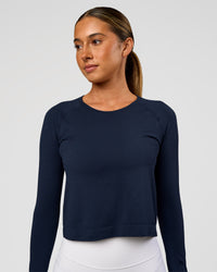 Woman wearing AeroFLX+ Seamless Long Sleeve Skimmer Tee - Future Navy/Future Navy | Model:Charli | Size:XS