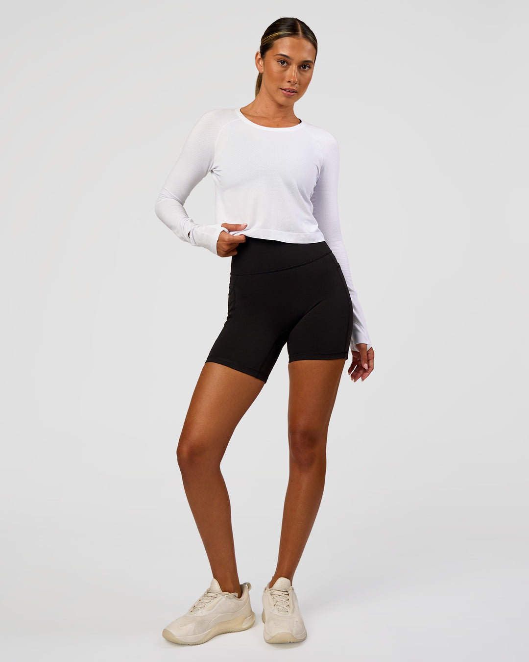 Woman wearing AeroFLX+ Seamless Long Sleeve Skimmer Tee - White/White | Model:Charli | Size:XS