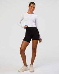 Woman wearing AeroFLX+ Seamless Long Sleeve Skimmer Tee - White/White | Model:Charli | Size:XS