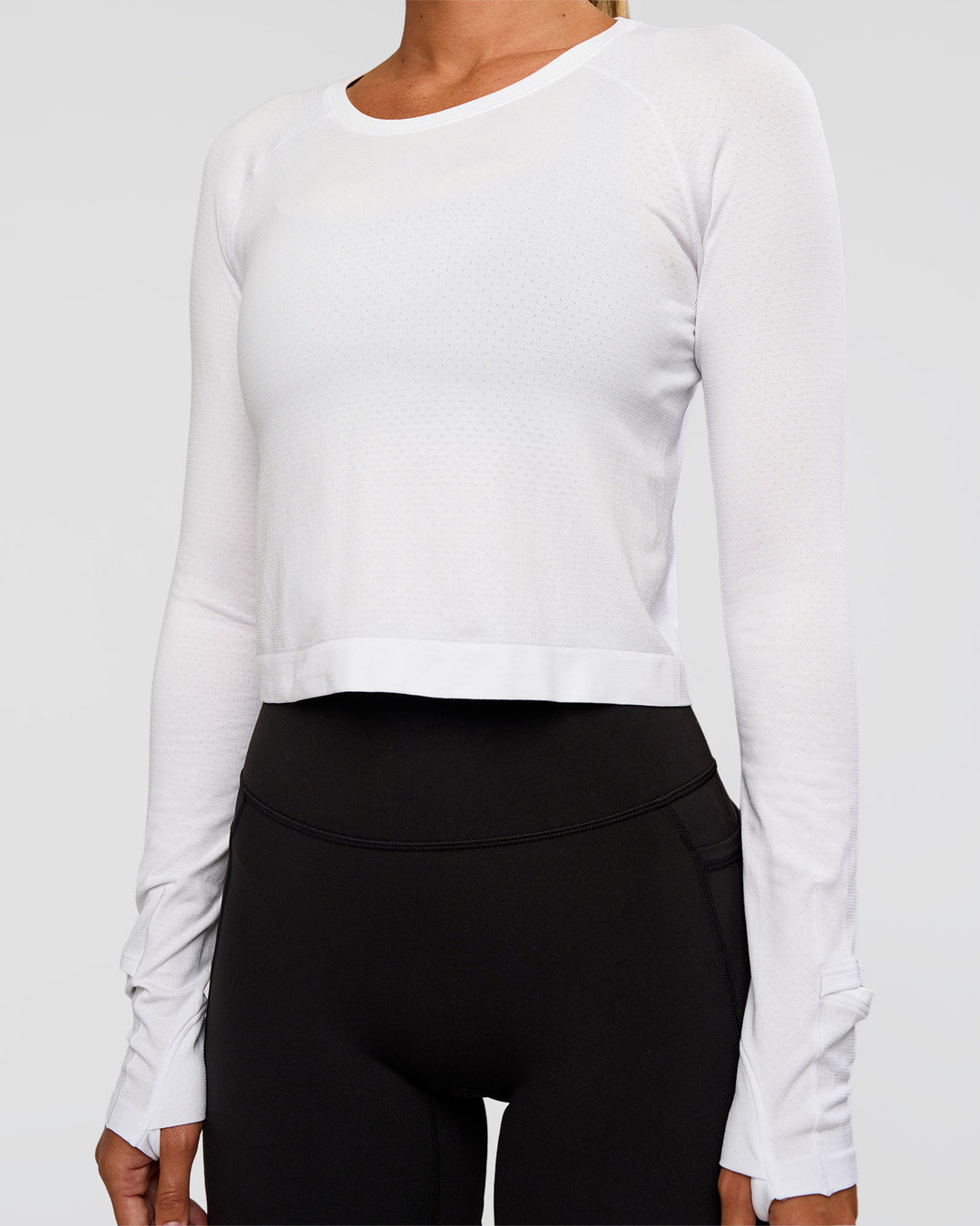 Woman wearing AeroFLX+ Seamless Long Sleeve Skimmer Tee - White/White | Model:Charli | Size:XS