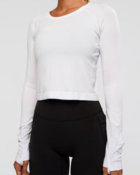 Woman wearing AeroFLX+ Seamless Long Sleeve Skimmer Tee - White/White | Model:Charli | Size:XS