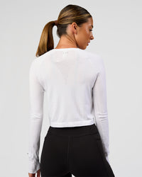 Woman wearing AeroFLX+ Seamless Long Sleeve Skimmer Tee - White/White | Model:Charli | Size:XS
