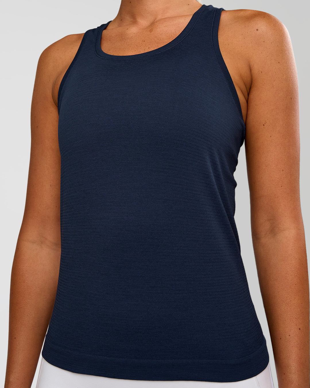 Woman wearing AeroFLX+ Seamless Tank - Future Navy/Future Navy | Model:Charli | Size:XS