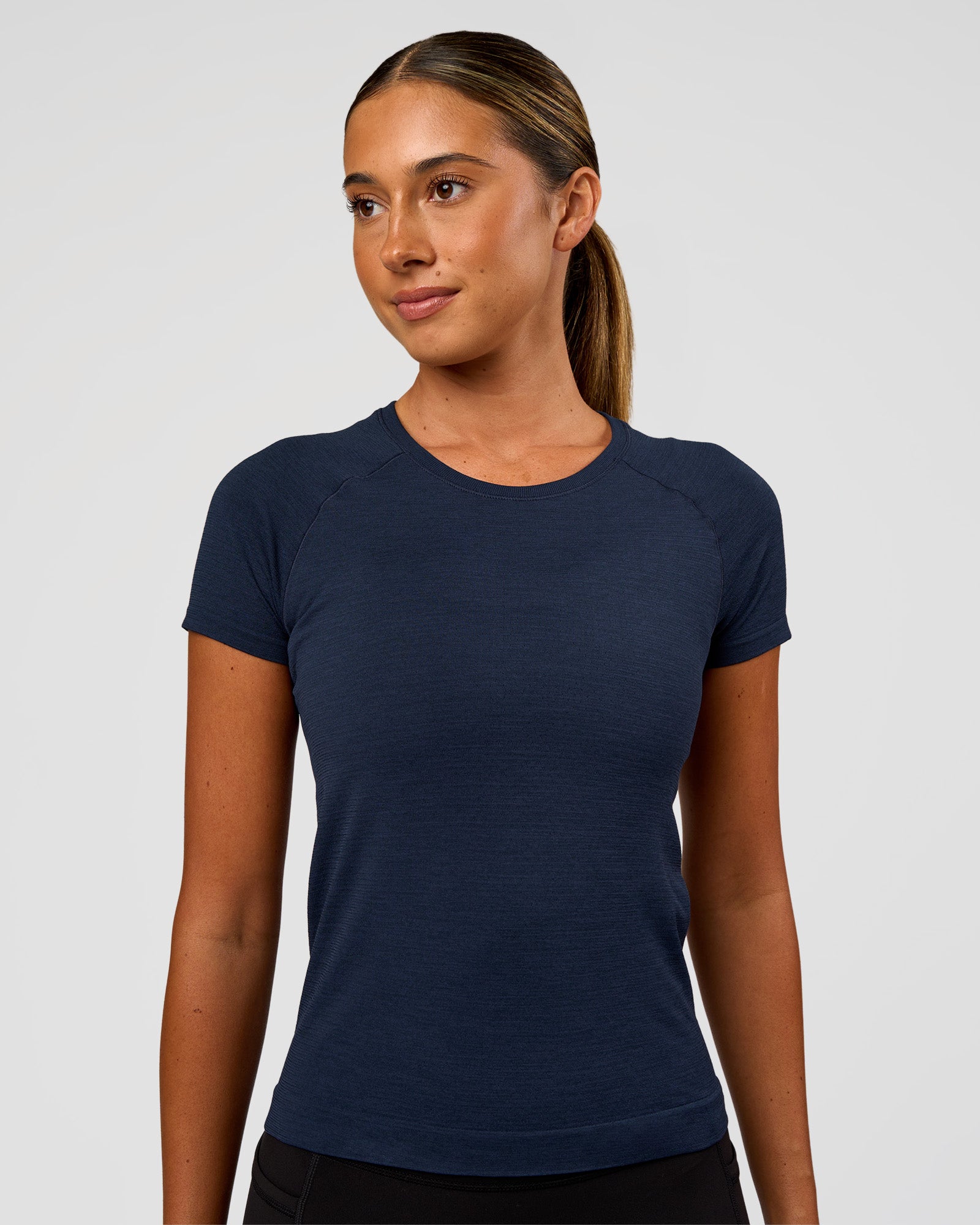 Woman wearing AeroFLX+ Seamless Tee - Future Navy/Future Navy | Model:Charli | Size:XS