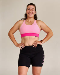 Campaign image of Accelerate Split Strap Sports Bra - Pink Rose-Ultra Pink | Thumbnail Index: 6