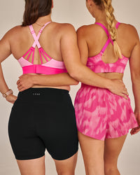 Campaign image of Accelerate Split Strap Sports Bra - Pink Rose-Ultra Pink | Thumbnail Index: 4