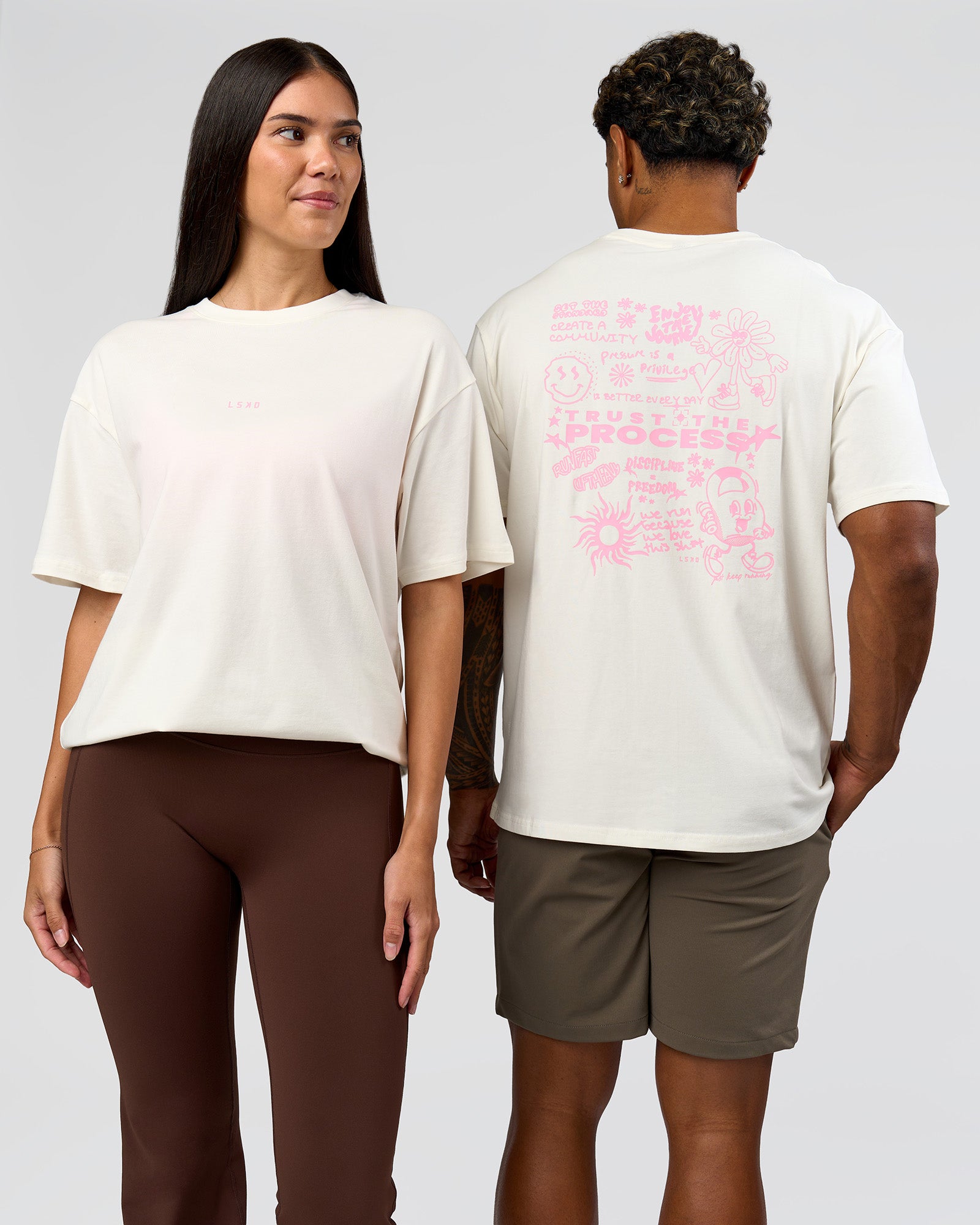 Duo wearing Built On Values FLXCotton Oversized Tee - Off White-Pink Rose | Model:Xav | Size:L | Model:Rhiley | Size:XS
