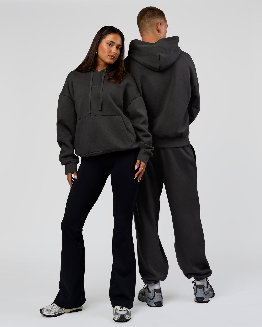 Duo wearing Base Oversized DC Hoodie - Onyx | Model:Albert | Size:M | Model:Bianca | Size:XS - view 7