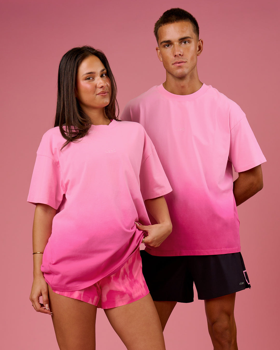 Duo wearing BCAM Ombre Heavyweight FLXCotton Oversized Tee  - Pink Rose-Ultra Pink | Model:Bianca | Size:S | Model:Albert | Size:M - view 1