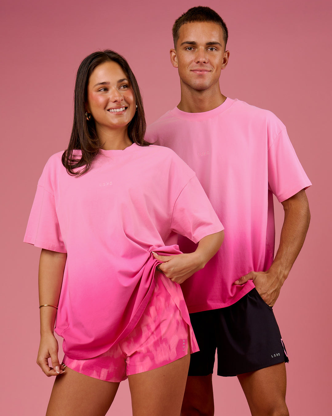 Duo wearing BCAM Ombre Heavyweight FLXCotton Oversized Tee  - Pink Rose-Ultra Pink | Model:Bianca | Size:S | Model:Albert | Size:M - view 16