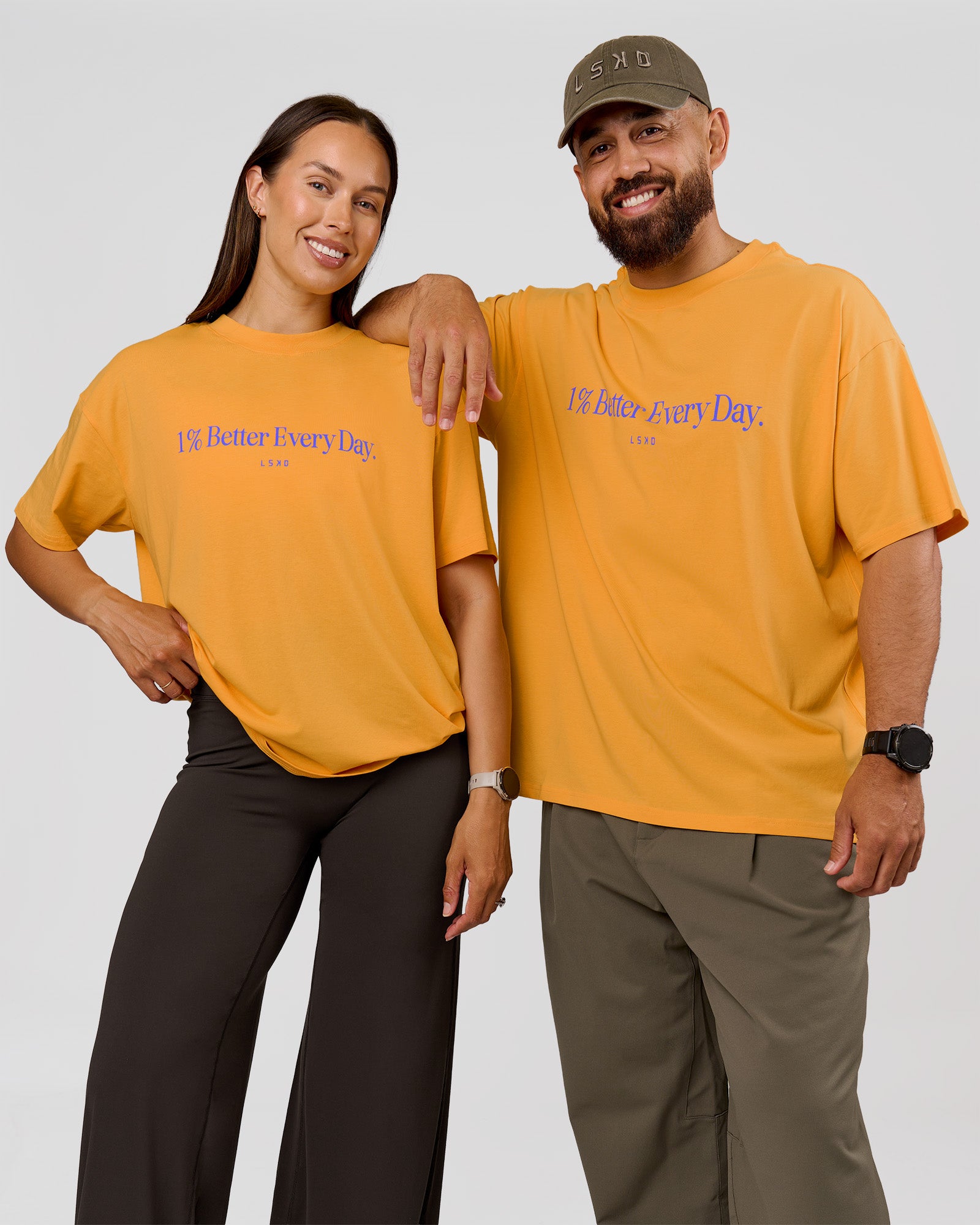 Duo wearing VS6 1% Better Fathers Day FLXCotton Oversized Tee - Warm Apricot | Model:Jess | Size:S | Model:Jordan | Size:XL