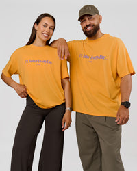Duo wearing VS6 1% Better Fathers Day FLXCotton Oversized Tee - Warm Apricot | Model:Jess | Size:S | Model:Jordan | Size:XL | Thumbnail Index: 0