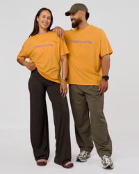 Duo wearing VS6 1% Better Fathers Day FLXCotton Oversized Tee - Warm Apricot | Model:Jess | Size:S | Model:Jordan | Size:XL | Thumbnail Index: 9
