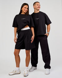 Duo wearing Andrew J. Steel x LSKD Heavyweight Boxed Tee - Black | Model:Bianca | Size:XS | Model:Jaiden | Size:L | Thumbnail Index: 2