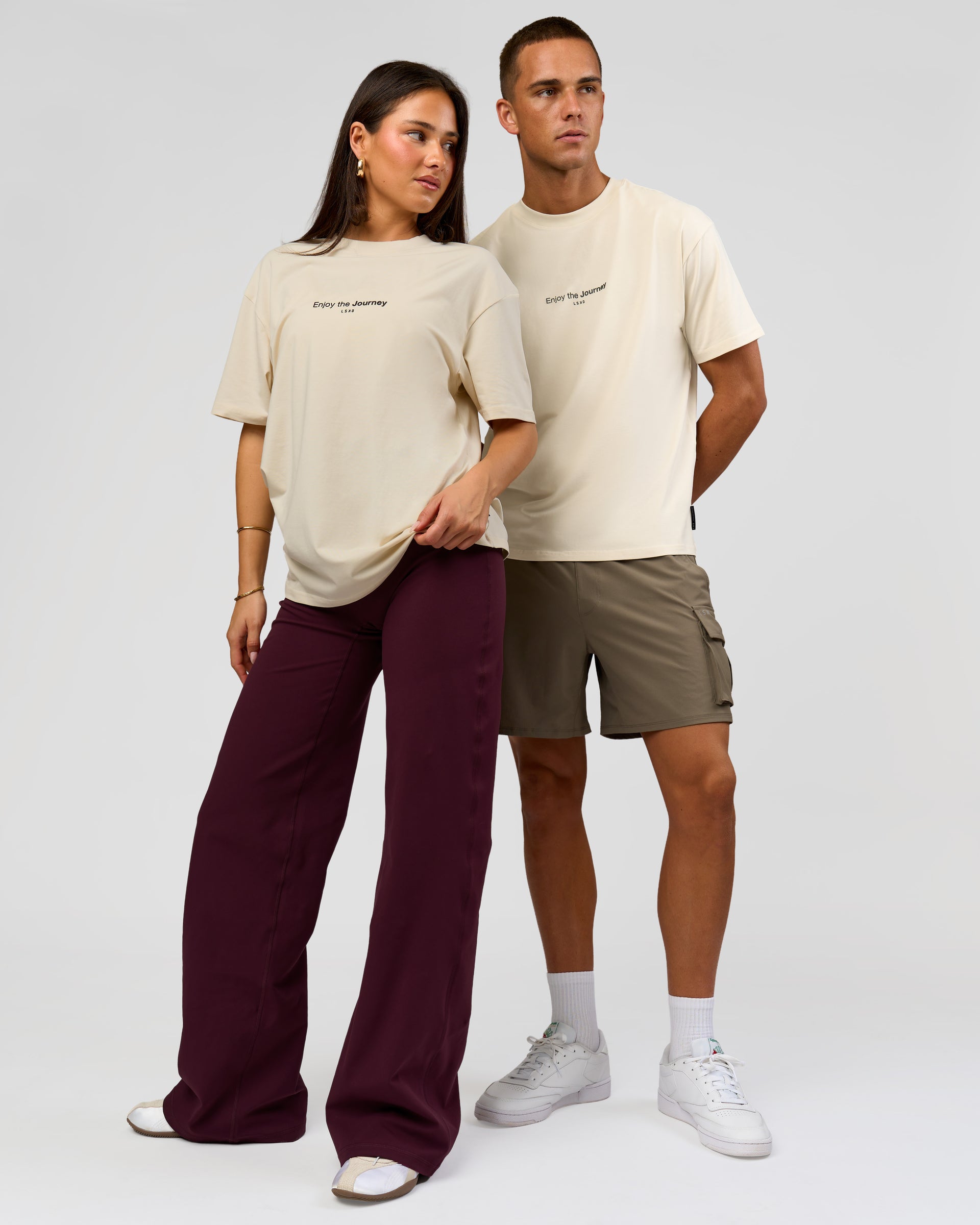 Duo wearing VS1 Enjoy The Journey FLXCotton Oversize Tee - Vanilla Bean | Model:Bianca | Size:XS | Model:Albert | Size:M
