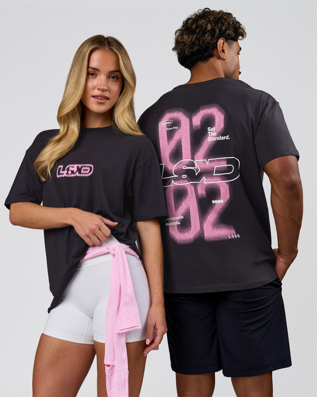 Duo wearing SoCal 26 FLXCotton Oversize Tee  - Onyx-Pink Rose | Model:Issy | Size:XS | Model:Xav | Size:L - view 1