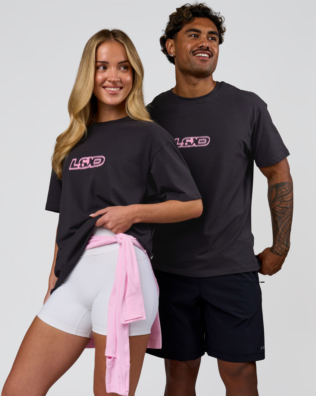 Duo wearing SoCal 26 FLXCotton Oversize Tee  - Onyx-Pink Rose | Model:Issy | Size:XS | Model:Xav | Size:L - view 7