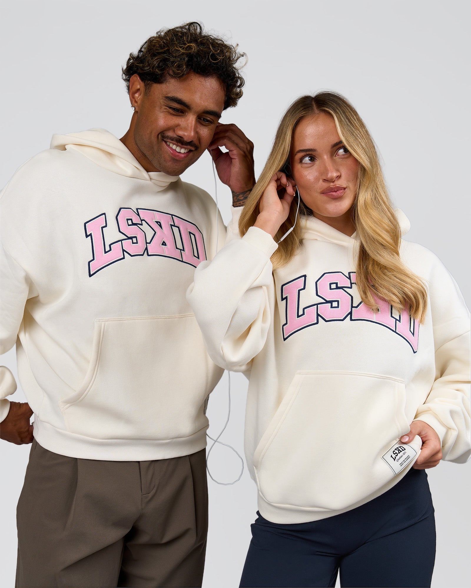 Duo wearing Varsity Boxy Hoodie - Off White-Pink Rose | Model:Issy | Size:XS | Model:Xav | Size:L