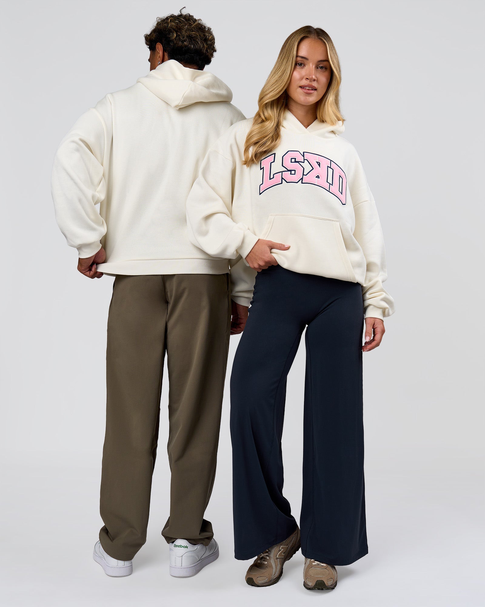 Duo wearing Varsity Boxy Hoodie - Off White-Pink Rose | Model:Issy | Size:XS | Model:Xav | Size:L
