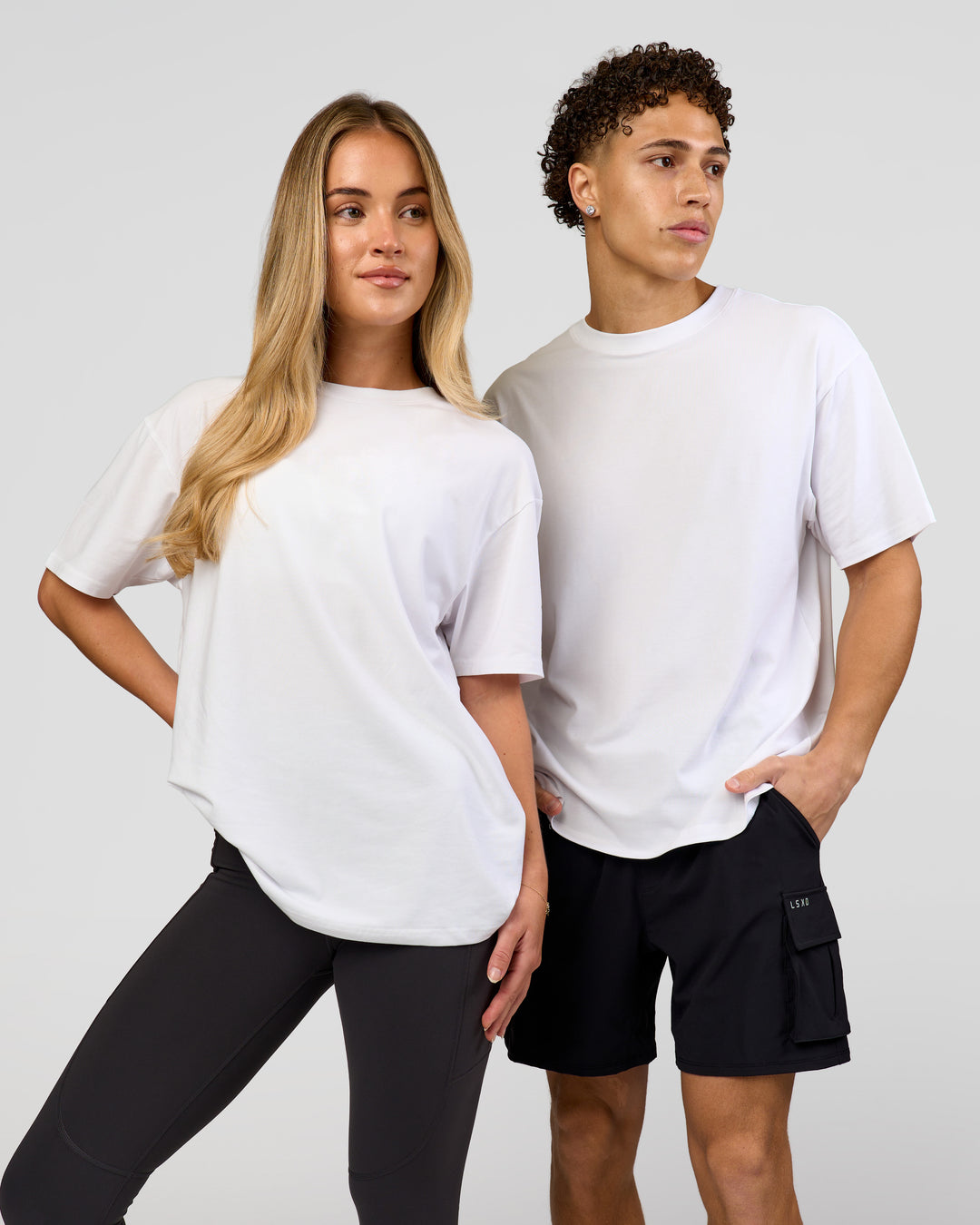 Duo wearing Benchmark FLXCotton Oversized Tee - White-Pale Lilac | Model:Issy | Size:XS | Model:Leandro | Size:M - view 4