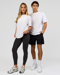 Duo wearing Benchmark FLXCotton Oversized Tee - White-Pale Lilac | Model:Issy | Size:XS | Model:Leandro | Size:M | Thumbnail Index: 9