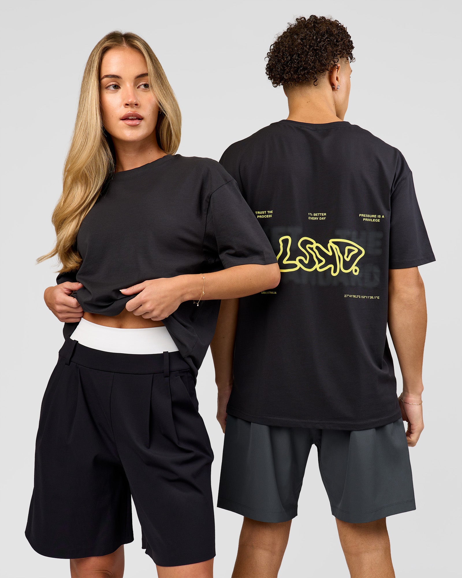 Duo wearing Benchmark FLXCotton Oversized Tee - Onyx-Yellow Fizz | Model:Issy | Size:XS | Model:Leandro | Size:M