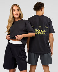 Duo wearing Benchmark FLXCotton Oversized Tee - Onyx-Yellow Fizz | Model:Issy | Size:XS | Model:Leandro | Size:M | Thumbnail Index: 0