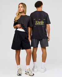 Duo wearing Benchmark FLXCotton Oversized Tee - Onyx-Yellow Fizz | Model:Issy | Size:XS | Model:Leandro | Size:M | Thumbnail Index: 2
